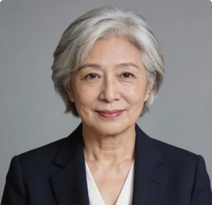 Professional headshot of an older woman with gray hair in a dark blazer